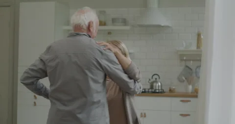 Happy elderly couple dancing together holding hands relaxing at home listening Stock Footage 241525554