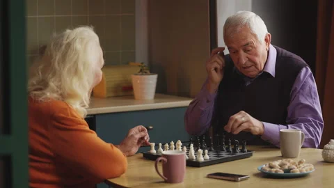Happy elderly couple enjoying a chess game at home, spending time together Stock Footage 337652285