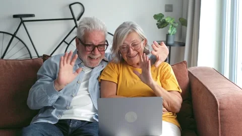 Happy Elderly Couple Making a Video Call on a Lapt 스톡 동영상 333201237