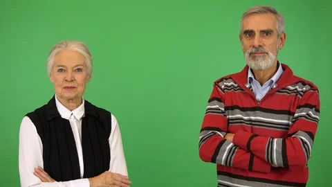 A happy elderly couple smiles at the camera and at each other - green screen Stock Footage 115067789