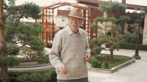Happy elderly dancer man dancing freestyle in the city Stock Footage 116319374