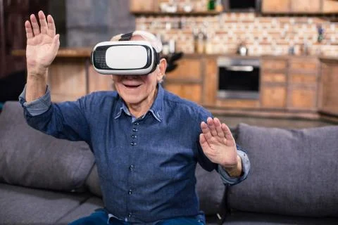 Happy elderly man testing VR device Stock Photos
