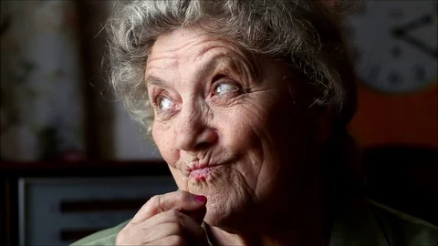 Happy elderly woman eating chocolate and smile Stock Footage
