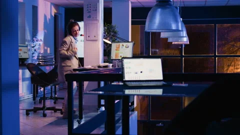 Happy employee analyzing graphs wearing headset Stock Footage 236511856