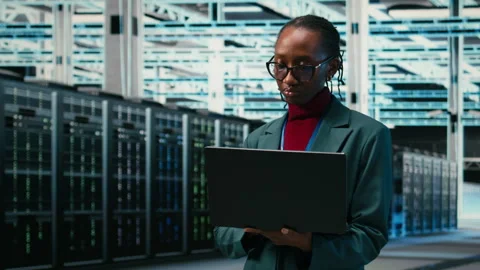 Happy employee in data center using laptop and digital twin virtualization Stock Footage 329532700