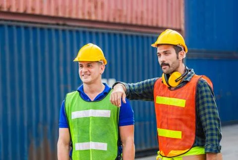 Happy Engineer and worker team checking containers box from cargo with blurre Stockfoto's