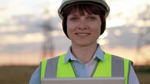 Happy engineer checkups technology via tablet at power distribution station Stock Footage 249028128