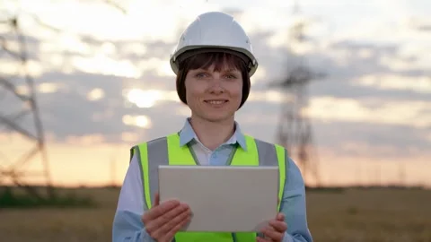 Happy engineer checkups technology via tablet at power distribution station Stock Footage 250151499