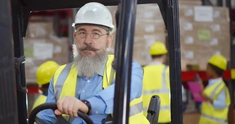Happy engineer operating forklift truck in warehouse Stock Footage 151402425