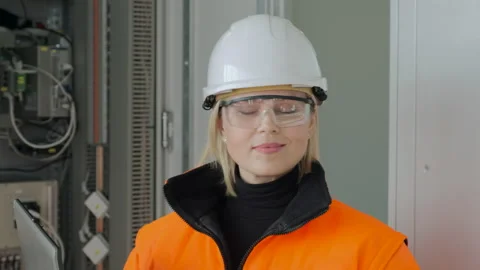 Happy engineer stands at electrical substation switchboard Stock Footage 144099085