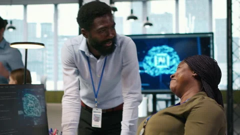 Happy engineers enjoying funny conversation at desk while using AI Stock Footage 313165846