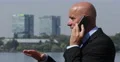 Happy Entrepreneur in Business with Office Buildings Use Cellphone for Negotiate 4k or 4k+ Resolution