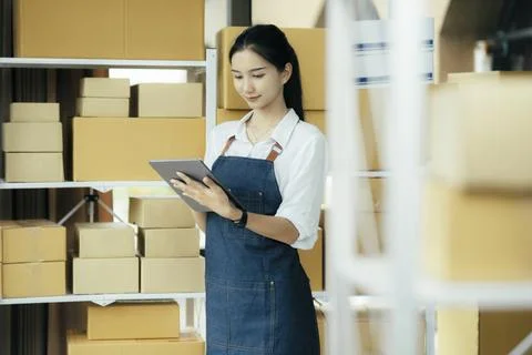 Happy entrepreneurs using tablets for check order and Checking stock for Stock Photos