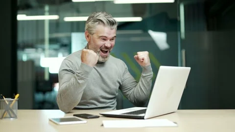 Happy excited mature gray haired bearded businessman celebrating his success  Stock Footage 232579331