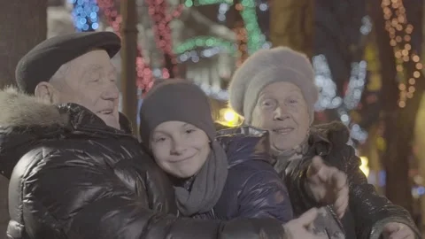 Happy excited old married couple grandparent hug grandchild boy grandson in chri Stockbeeldmateriaal 132674053