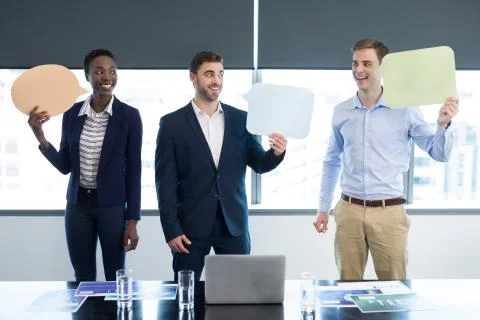 Happy executives holding speech bubble Stock Photos
