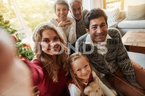 Happy extended family taking self portrait on christmas eve Stock Photos