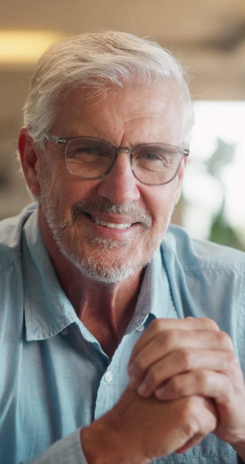 Happy, face and senior man in home for relax, chill and enjoy weekend in living Stock Footage 335943013