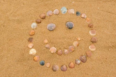 Happy face on the beach Stock Photos