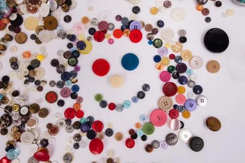 Happy face created with assorted sewing buttons smiling Stock Photos