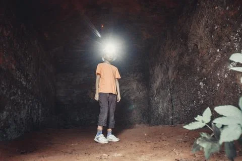 Happy face exploring cave architecture. Solo adventure connecting Stock Photos