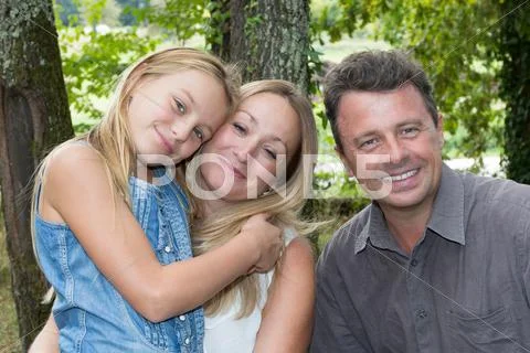 Happy family with blond teen girl outdoors Stock Photos