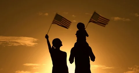 Happy family celibrating holding American flags Stock Footage