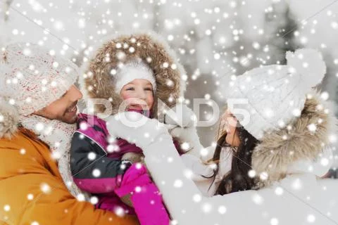 Happy family with child in winter clothes outdoors Stock Photos