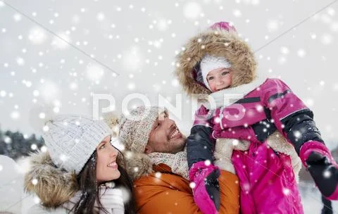 Happy family with child in winter clothes outdoors Stock Photos