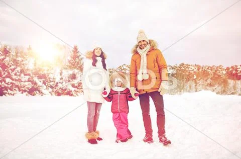 Happy family with child in winter clothes outdoors Stock Photos