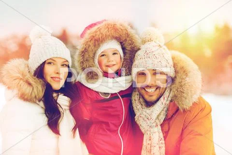 Happy family with child in winter clothes outdoors Stock Photos