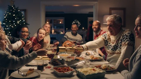 Happy family christmas dinner party celebrating with crackers sharing homemade Stock Footage 110757597