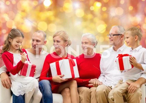 Happy family with christmas gifts over lights Stock Photos