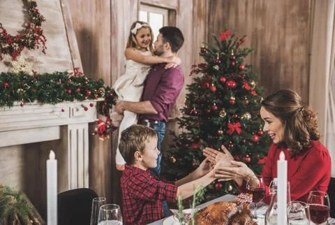 Happy family at christmastime Stock Photos