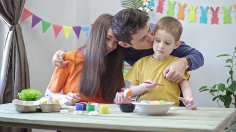 Happy family is coloring Easter eggs in a decorated room Stock Footage 196226947