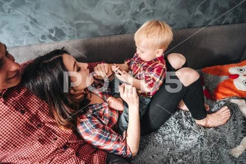 Happy family on the couch Stock Photos