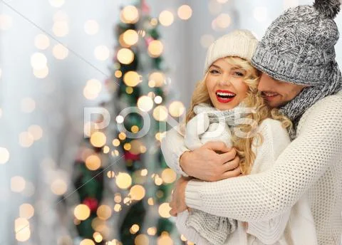 Happy family couple in winter clothes hugging Stock Photos
