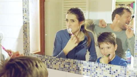 Happy family with dancing father while washing teeth in bathroom Stock Footage 73975566