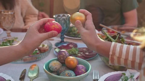 Happy family at dining table on Easter day outdoors. Caucasian family eating an Stock Footage 237536524