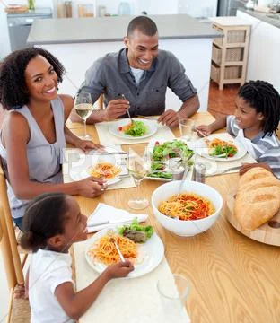Happy family dining together Stock Photos