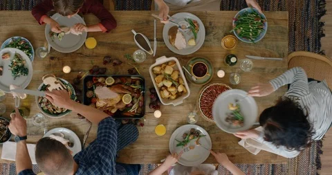 Happy family eating thanksgiving lunch together enjoying healthy homemade feast Stock Footage