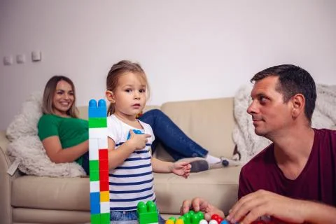 Happy family - Father and child girl play together with educational toys. Stock Photos