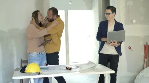 Happy family getting good news on cellphone at their new home Stock Footage