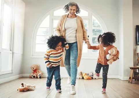 Happy family, grandmother and children play hopscotch in home having fun, enjoy Stock Photos