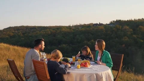 Happy family have lunch in nature Stock Footage