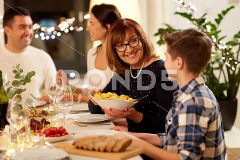 Happy family having dinner party at home Stock Photos