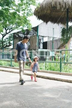 Happy family having fun with animals safari park on warm summer day. Stock Photos