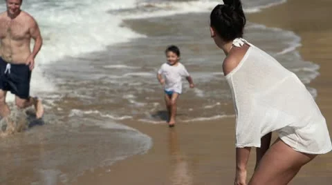 Happy family having fun on the beach HD Stock Footage
