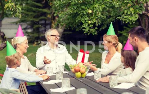 Happy family having holiday dinner outdoors Stock Photos