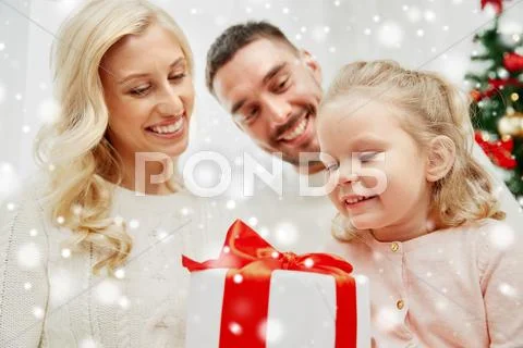 Happy family at home with christmas gift box Stock Photos
